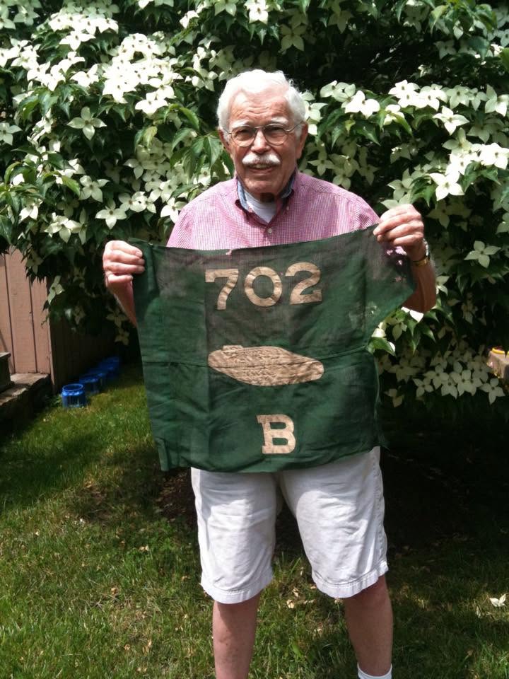 Jack holding a hand-lettered 702 B flag